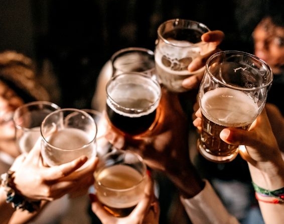 Gruppe von Menschen stößt mit Winterbockbier bei einer Feier an.